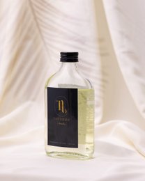 Clear glass bottle, black cap, golden liquid fragrance refill sticks, minimalist luxury design
