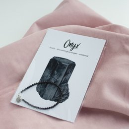 Black onyx gemstone bracelet with natural stone texture and irregular shape.