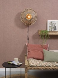 A round, woven wall lamp with a warm, glowing light source in the center. The lamp has a natural, earthy color palette and a textured, intricate design.