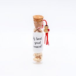 A glass bottle filled with a cork stopper, containing a message that reads "By heart you'll soar!". The bottle has a red ribbon tied around it, adding a decorative touch.