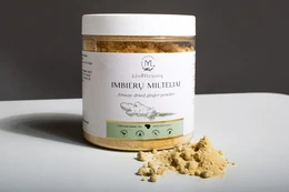  Freeze-dried ginger powder, a single spice product in a white container with a gold lid. The powder has a vibrant yellow-orange color and a coarse, granular texture.