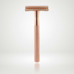 Rose gold metal razor with textured handle for a sustainable shaving experience.