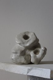 Handmade ceramic candle holder with a unique, organic shape and textured surface. Suitable for use as a decorative accent or to hold tealight candles.