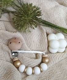 Gold pacifier clip with white beads and green plant