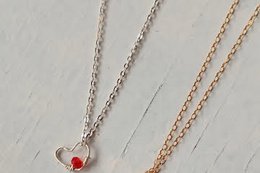  Delicate silver and gold-toned heart-shaped pendant necklaces with a small red accent.