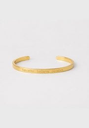 Gold cuff bracelet with engraved text, minimalist open bangle design, polished metal finish