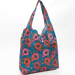 A dark blue shopper bag made of recycled nylon with a vibrant floral print in shades of red, orange, and turquoise.
