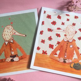 "Mr. & Mrs. Poodle Art Print Set, 21 x 21 cm - Posters featuring two poodle characters, one drinking coffee and the other tea, with a whimsical, illustrated style."

The product is a set of two art prints featuring poodle characters. The prints have a whimsical, illustrated style with warm, earthy tones. One print shows a poodle character drinking coffee, while the other shows a poodle character drinking tea. The prints have a square format measuring 21 x 21 cm.