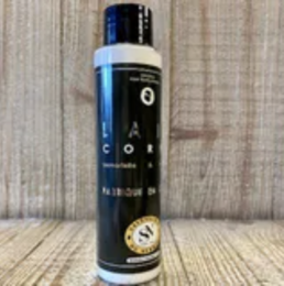 Lait Corps - Immortelle & Amande is a cream product available in 250 ml and 100 ml sizes. The product features a white bottle with a black pump dispenser. The cream is made with immortelle and almond ingredients.