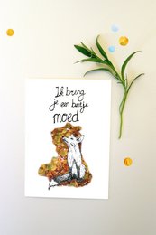 A greeting card featuring a cute illustration of a fox and a daisy flower. The text on the card reads "It's a good day to be happy!"