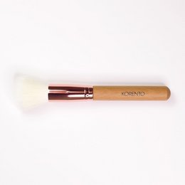 Stippling makeup brush with wooden handle and metal ferrule. Designed for applying and blending foundation, powder, and other makeup products.