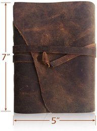 A rustic, leather-bound notebook with a distressed, vintage appearance. The notebook features a wrap-around leather cover with a strap closure, giving it a classic, handcrafted look. The pages inside are blank, allowing for customizable bullet journaling or note-taking.