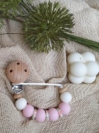 Newborn pacifier clip with rose design, made of soft, durable materials. Features a floral pattern in shades of pink and green.