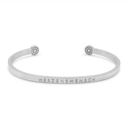 A silver or gold-toned cuff bracelet with a heart-shaped charm and the text "BELIEVE IN YOURSELF" engraved on the band. The bracelet features a minimalist, elegant design suitable for everyday wear.