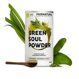 Organic green superfood powder in a canister, with fresh green leaves and a spoon. The powder is a natural, nutrient-rich supplement made from green vegetables.