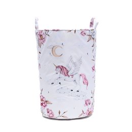 A round, tall basket with a white background featuring a unicorn and floral pattern. The basket has a pink drawstring closure at the top.