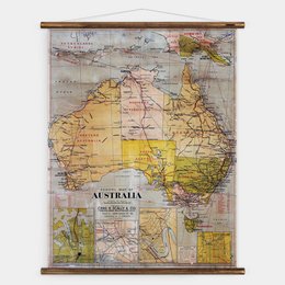 A vintage map of Australia, featuring the country's geographic regions and landmarks. The map is displayed on a wooden frame, creating a rustic and educational wall art piece.