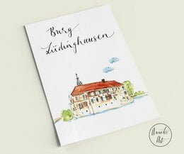 Postcard featuring a watercolor illustration of Lüdinghausen Castle, part of the Ludinghausen series. The postcard depicts a traditional European castle with red roofs and green landscaping.