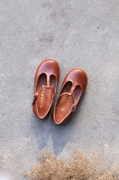  Handmade leather girls' ballet flats in cognac brown, available in sizes 22-30. Featuring a classic round toe and slip-on design for comfortable, stylish footwear.