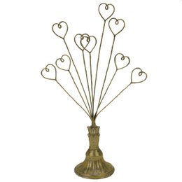 Gold card holder with heart-shaped stems, decorative metal display stand for photos and cards.