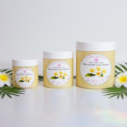  Tropical body butter with white and yellow flowers, creamy texture, moisturizing skincare product.