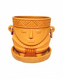 A round, tall orange ceramic planter with a decorative face design and handles on the sides. The planter appears to be made of a durable material and is suitable for indoor or outdoor use.