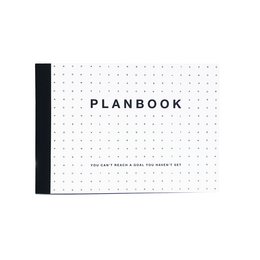 A white and black planbook with a simple, minimalist design. The planbook has a grid layout with days of the week printed on it, making it suitable for organizing schedules and plans.