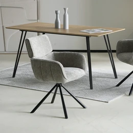  Set of 2 Elara swivel chairs in chenille fabric with a wooden dining table. The chairs have a modern, minimalist design with black metal legs and a gray upholstered seat and back.