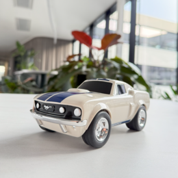  Beige toy racing car with blue stripes, resembling a Ford Mustang. Compact, classic sports car shape with rounded front and rear.