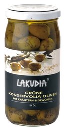 Green Konservolia olives with herbs and spices, packed in a glass jar. Olives with a rich, savory flavor from the added seasonings.