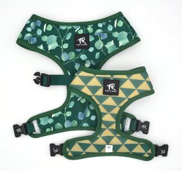 Green dog harness with leaf pattern, adjustable straps, and buckle closure. Suitable for small to medium dogs.