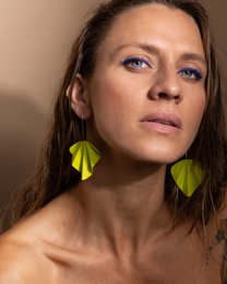 Lime green drop earrings with a geometric, origami-inspired design. Made of lightweight, durable material.