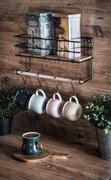 A floating wall shelf with a kitchen roll holder and multifunctional spice rack in a matte black finish. The shelf features a rustic, industrial design with a wooden base and metal frame, providing storage and organization for the kitchen.