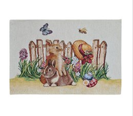  Decorative placemat featuring a Gobelin-style illustration of rabbits, butterflies, and other Easter-themed elements in a garden setting.