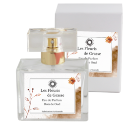 Perfume with a warm, woody scent featuring notes of oud wood. Packaged in a sleek, minimalist design.