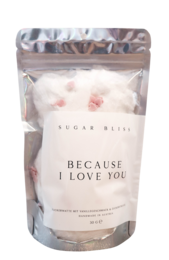 Soft, fluffy cotton candy in a resealable bag with the text "BECAUSE I LOVE YOU" printed on the packaging. The cotton candy is a light pink color, creating a sweet and romantic presentation.