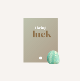  A green, oval-shaped crystal with the text "Bringing Luck" on a gray background.