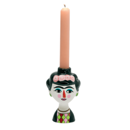  A round, tall pink candle holder in the shape of a Frida Kahlo-inspired figure, with a colorful, decorative design.