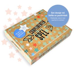 A colorful box containing a game with various compliment cards inside. The game is designed to encourage positive interactions and boost self-esteem.