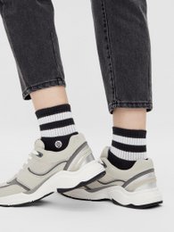 Black and white striped athletic socks with retro styling and logo.