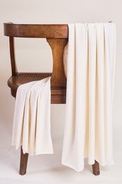 Off-white cream modal jersey fabric, soft drape, lightweight textile material for dresses.