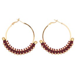  Colorful golden hoop earrings with beaded accents in blue, fuchsia, green, black, and navy blue.