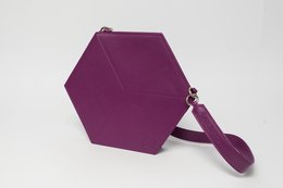 Hexagonal purple handbag with a strap for carrying.