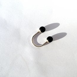 Two black statement rings with various size and color options, including silver and gold.