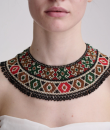  "Beaded necklace, green red gold geometric pattern, wide collar style, black beads, tassel detail"