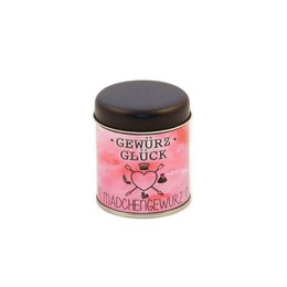A small pink and white spice jar labeled "Gewürz Glück" (Spice Luck) containing a seasoning blend with visible speckles or flecks, likely a spice mix or seasoning blend.