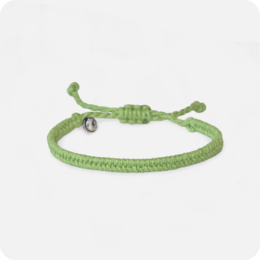 Green woven bracelet with adjustable cord and metal charm.