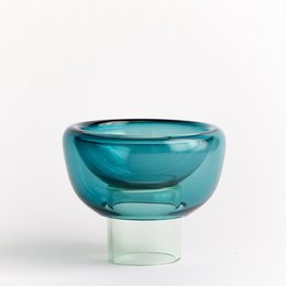 Decorative glass bowl in shades of green, with a round, spherical shape.