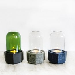 Decorative glass candle holder with a green glass dome and black hexagonal base. Available in various color combinations.