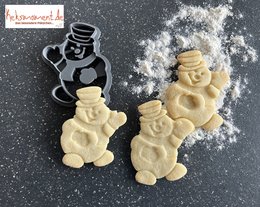 Snowman-shaped baking decorations, made of dough, with a black cookie cutter in the shape of a snowman.